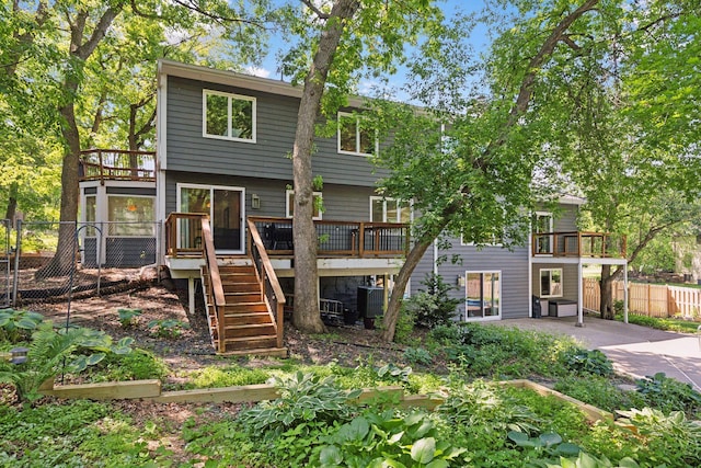 8155 134th St W, Apple Valley, MN 55124 - back of property featuring stairs, a wooden deck, a patio area, and a balcony