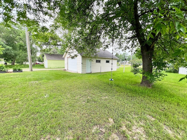 211 5th St NE, Barnesville, MN 56514 - view of green lawn featuring an outbuilding and a detached garage