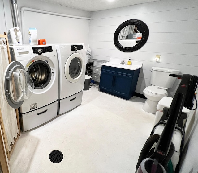 211 5th St NE, Barnesville, MN 56514 - washroom featuring washer and dryer and wood walls