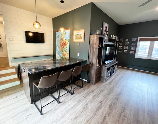 211 5th St NE, Barnesville, MN 56514 - dining area featuring light wood-style flooring and wood walls
