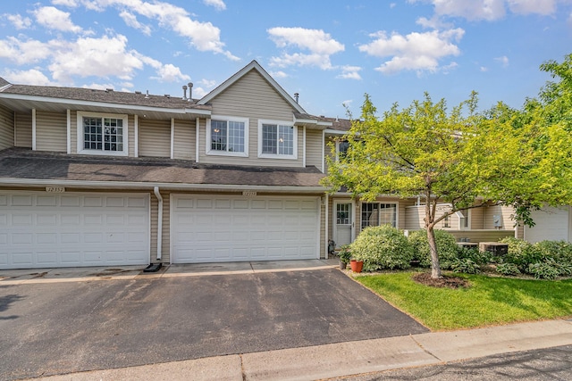 12359 Zealand Ave N, Champlin, MN 55316 - townhome / multi-family property featuring asphalt driveway, a garage, and a shingled roof