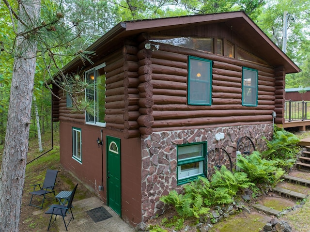 3938 State Road 77, Swiss Twp, WI 54830 - view of home's exterior featuring log siding, stone siding, and a patio