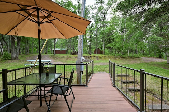 3938 State Road 77, Swiss Twp, WI 54830 - deck featuring a storage shed, outdoor dining space, and a lawn