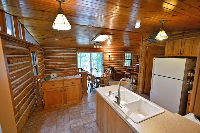 3938 State Road 77, Swiss Twp, WI 54830 - kitchen with freestanding refrigerator, rustic walls, wooden ceiling, decorative light fixtures, and lofted ceiling