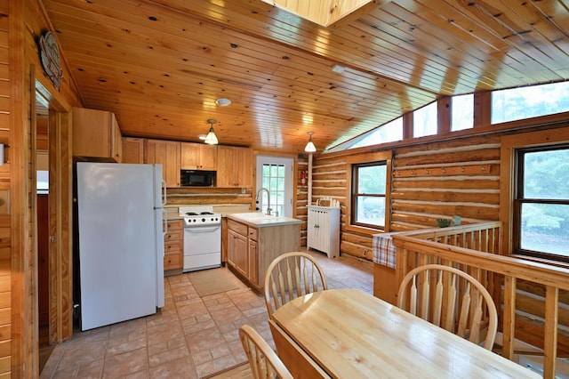 3938 State Road 77, Swiss Twp, WI 54830 - kitchen featuring white appliances, log walls, plenty of natural light, light countertops, and a skylight