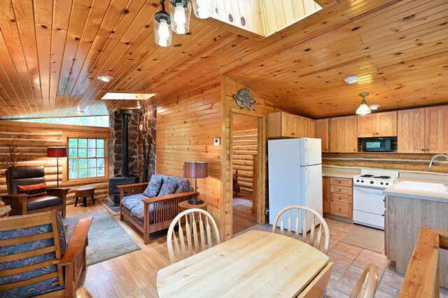3938 State Road 77, Swiss Twp, WI 54830 - dining area featuring vaulted ceiling, log walls, wood ceiling, a wood stove, and light wood-style floors