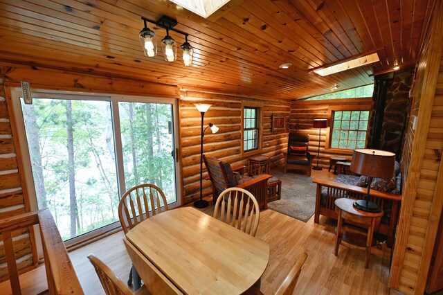 3938 State Road 77, Swiss Twp, WI 54830 - dining area with a skylight, log walls, wood finished floors, vaulted ceiling, and wooden ceiling