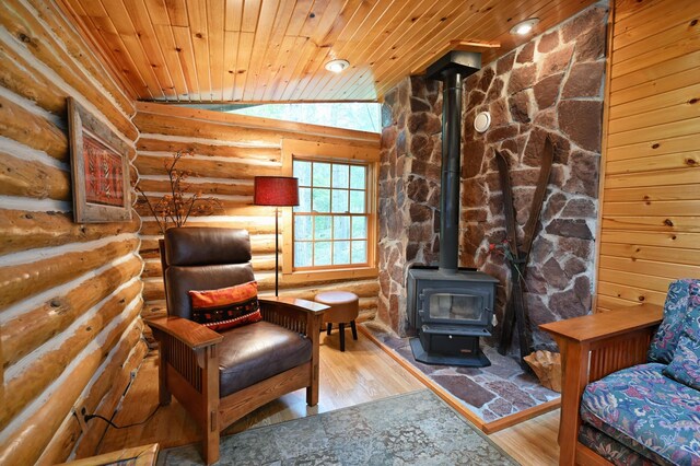 3938 State Road 77, Swiss Twp, WI 54830 - sitting room with a wood stove, wooden ceiling, vaulted ceiling, log walls, and wood finished floors