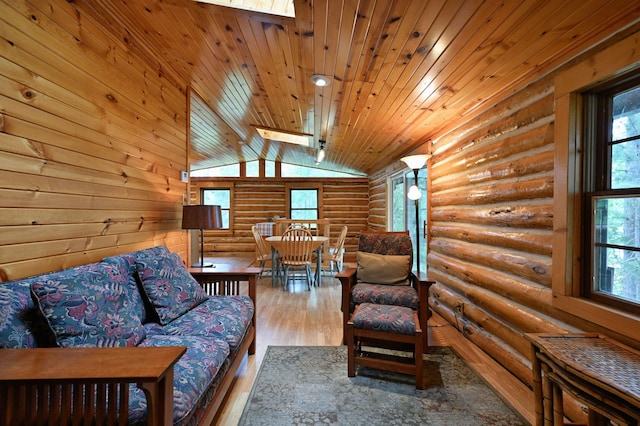 3938 State Road 77, Swiss Twp, WI 54830 - living area featuring log walls, plenty of natural light, vaulted ceiling, wood ceiling, and wood finished floors