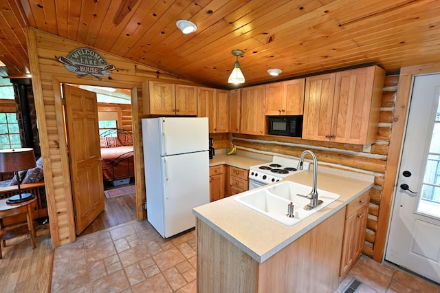 3938 State Road 77, Swiss Twp, WI 54830 - kitchen featuring white appliances, vaulted ceiling, plenty of natural light, light countertops, and a peninsula