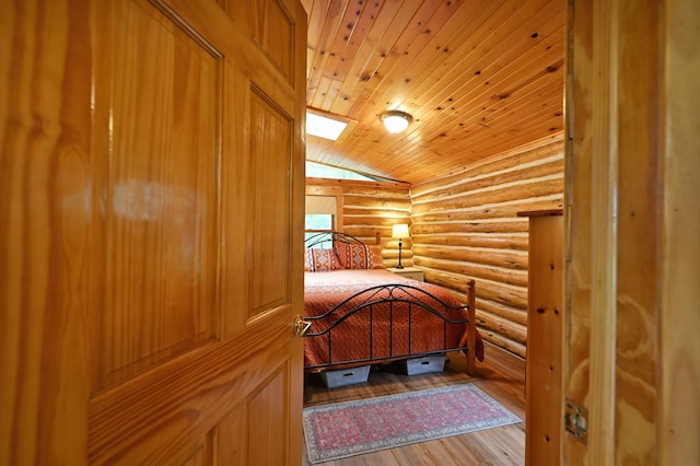 3938 State Road 77, Swiss Twp, WI 54830 - unfurnished bedroom with rustic walls, wooden ceiling, lofted ceiling, and wood finished floors