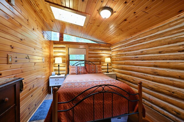 3938 State Road 77, Swiss Twp, WI 54830 - bedroom with vaulted ceiling, wooden ceiling, a skylight, rustic walls, and wood finished floors