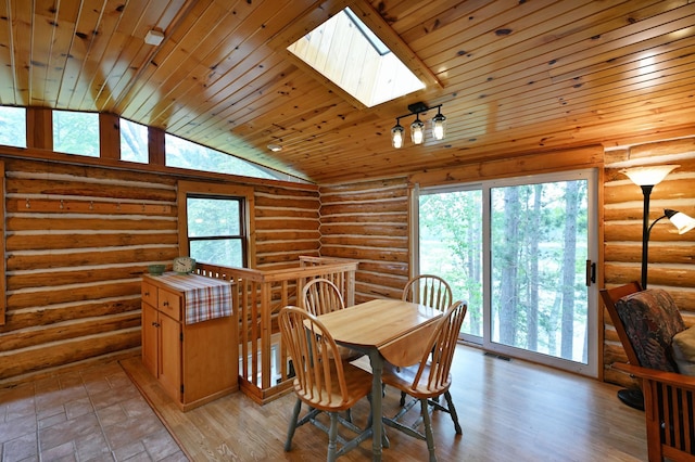 3938 State Road 77, Swiss Twp, WI 54830 - dining room featuring vaulted ceiling, healthy amount of natural light, a skylight, wooden ceiling, and log walls