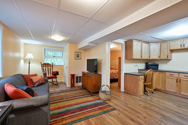 3938 State Road 77, Swiss Twp, WI 54830 - living room with light wood-type flooring and a paneled ceiling