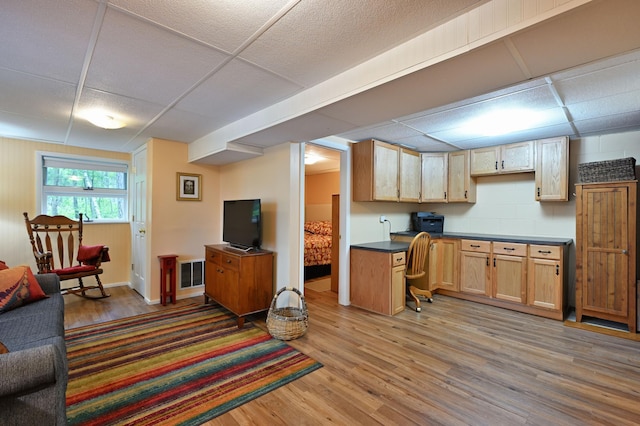 3938 State Road 77, Swiss Twp, WI 54830 - kitchen with a drop ceiling, light wood-type flooring, open floor plan, and dark countertops