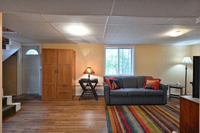 3938 State Road 77, Swiss Twp, WI 54830 - living room with a paneled ceiling, light wood finished floors, wooden walls, and stairway