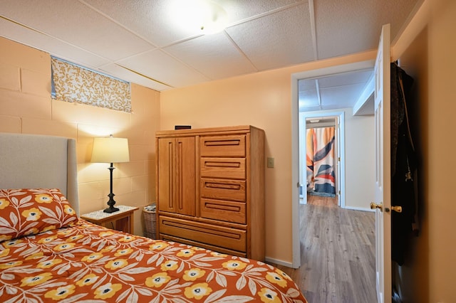 3938 State Road 77, Swiss Twp, WI 54830 - bedroom with concrete block wall and light wood-style floors