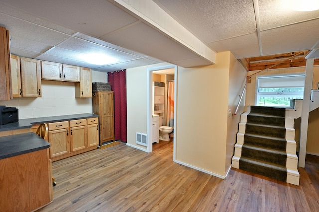 3938 State Road 77, Swiss Twp, WI 54830 - kitchen with light wood-type flooring, dark countertops, and a paneled ceiling