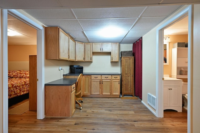 3938 State Road 77, Swiss Twp, WI 54830 - kitchen featuring a paneled ceiling, light wood finished floors, and dark countertops