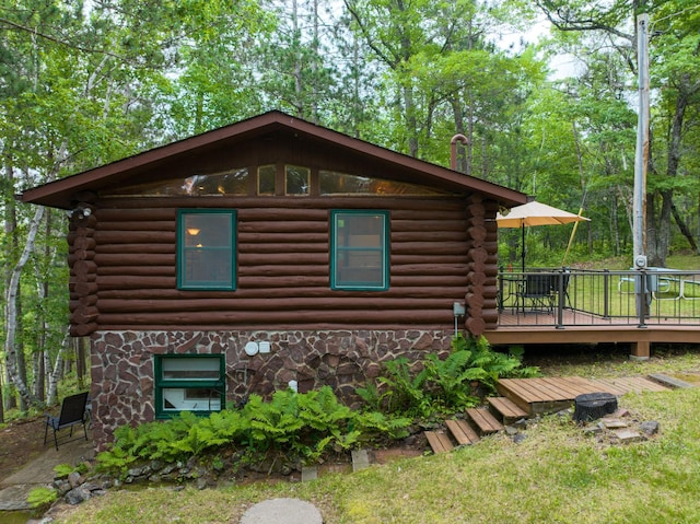 3938 State Road 77, Swiss Twp, WI 54830 - view of home's exterior featuring log siding, a wooden deck, and stone siding