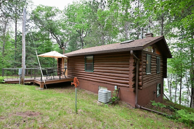 3938 State Road 77, Swiss Twp, WI 54830 - view of property exterior with log siding, a chimney, a deck, roof with shingles, and a yard