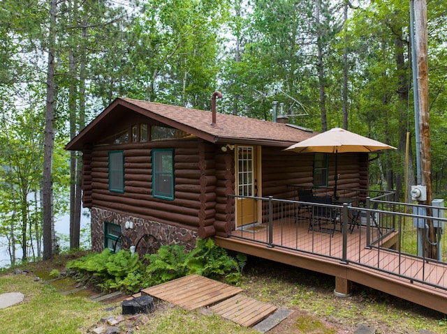 3938 State Road 77, Swiss Twp, WI 54830 - rear view of property with log exterior, a wooden deck, and roof with shingles