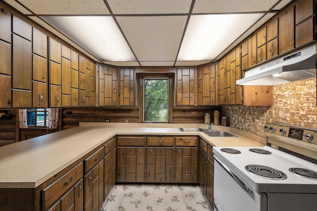 21750 Elk Lake Rd NW, Elk River, MN 55330 - kitchen featuring white electric range oven, under cabinet range hood, a sink, light countertops, and log walls