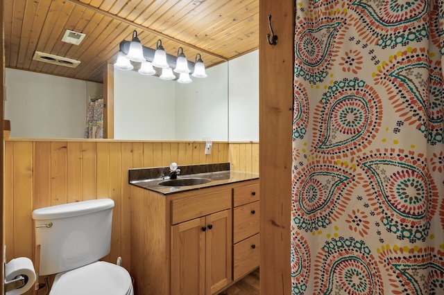 21750 Elk Lake Rd NW, Elk River, MN 55330 - bathroom featuring a wainscoted wall, vanity, toilet, wood ceiling, and wooden walls