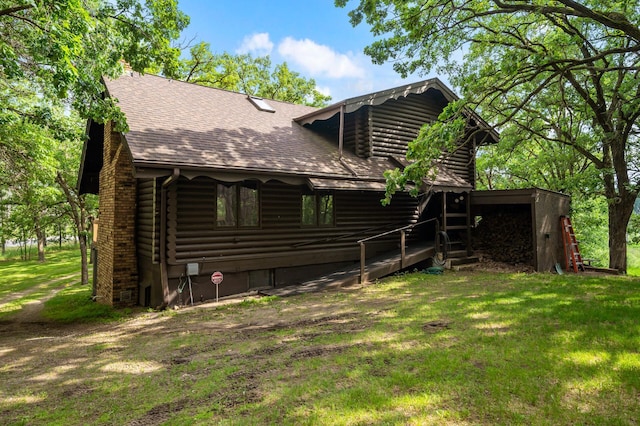 21750 Elk Lake Rd NW, Elk River, MN 55330 - back of house with log siding, roof with shingles, a yard, and a chimney