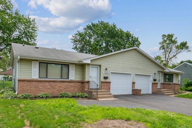 7007 Portland Ave, Richfield, MN 55423 - ranch-style house with brick siding, an attached garage, and driveway