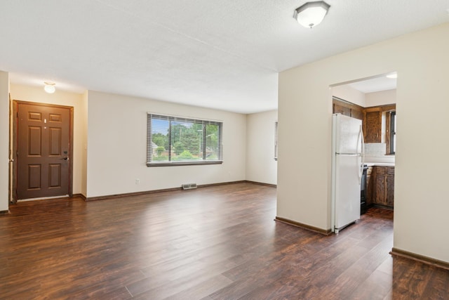7007 Portland Ave, Richfield, MN 55423 - unfurnished living room with dark wood-style flooring and baseboards