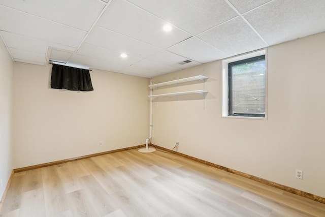 7007 Portland Ave, Richfield, MN 55423 - basement featuring light wood finished floors, baseboards, and a paneled ceiling