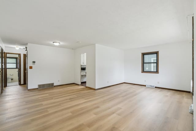 7007 Portland Ave, Richfield, MN 55423 - unfurnished living room featuring light wood finished floors and baseboards