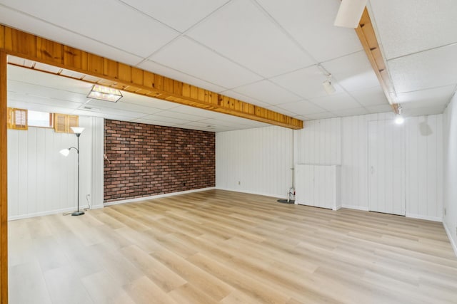 7007 Portland Ave, Richfield, MN 55423 - finished below grade area with brick wall, wood finished floors, baseboards, and a drop ceiling