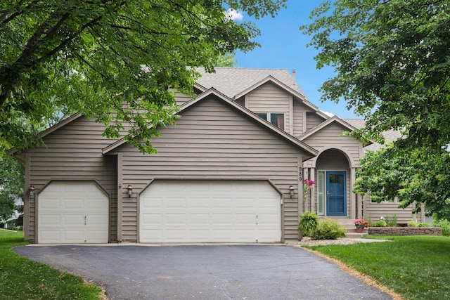 989 Coneflower Ct, Eagan, MN 55123 - traditional-style home featuring asphalt driveway, a front lawn, and a shingled roof