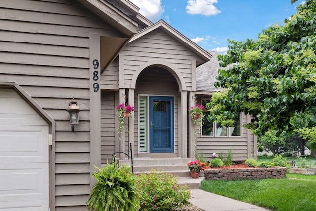 989 Coneflower Ct, Eagan, MN 55123 - doorway to property featuring an attached garage and roof with shingles