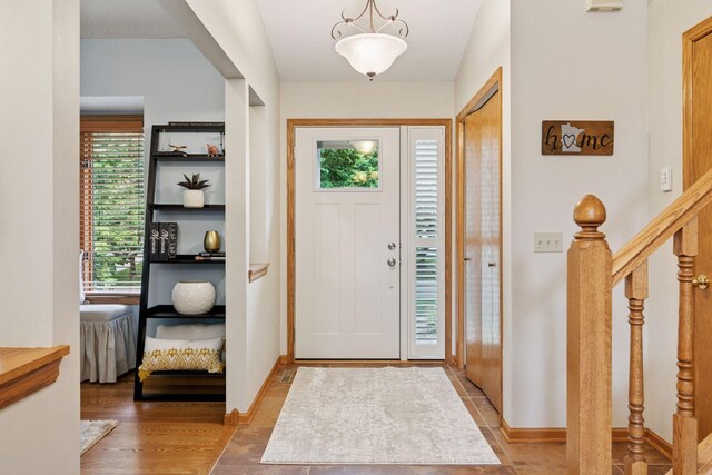 989 Coneflower Ct, Eagan, MN 55123 - entrance foyer featuring stairway and baseboards