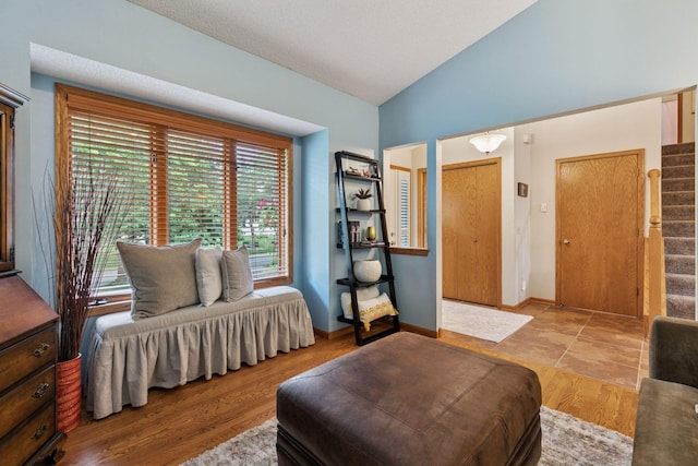 989 Coneflower Ct, Eagan, MN 55123 - living area featuring vaulted ceiling, healthy amount of natural light, stairway, and wood finished floors