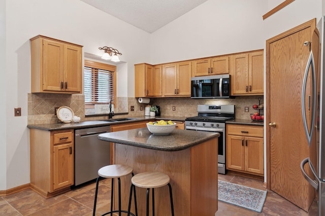 989 Coneflower Ct, Eagan, MN 55123 - kitchen featuring stainless steel appliances, dark countertops, a center island, decorative backsplash, and a kitchen bar