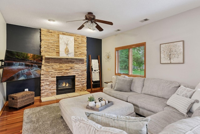 989 Coneflower Ct, Eagan, MN 55123 - living room with a ceiling fan, wood finished floors, and a stone fireplace
