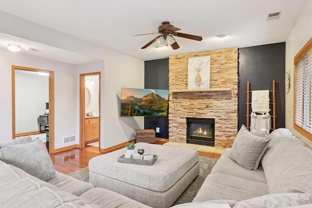 989 Coneflower Ct, Eagan, MN 55123 - living area featuring a ceiling fan, a stone fireplace, and wood finished floors
