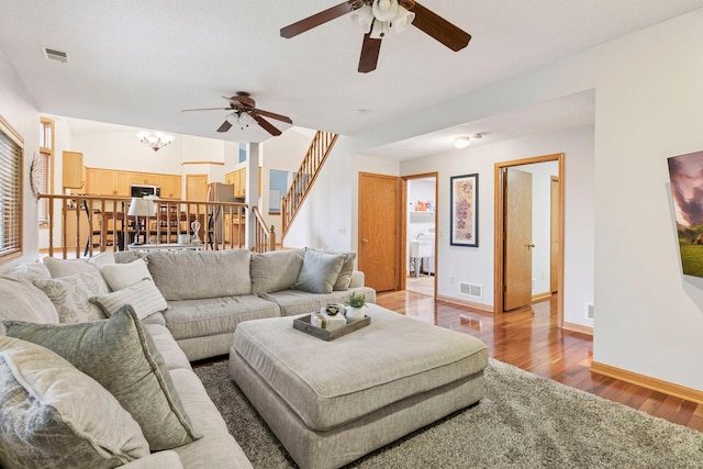 989 Coneflower Ct, Eagan, MN 55123 - living room with ceiling fan, light wood-style flooring, stairway, and a chandelier