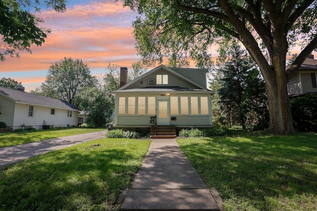 1384 Midway Pkwy, Saint Paul, MN 55108 - bungalow-style house with entry steps, a chimney, and a front lawn