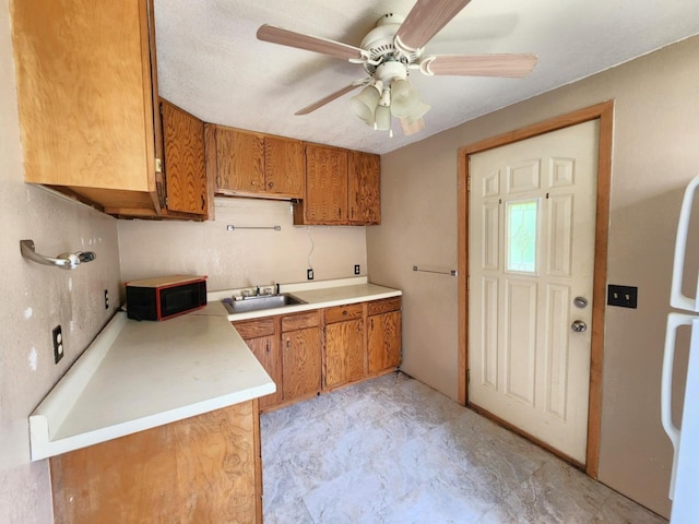 14 4th Ave SE, Dodge Center, MN 55927 - kitchen with a sink, black microwave, brown cabinets, ceiling fan, and light countertops