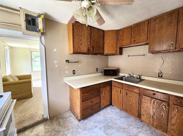 14 4th Ave SE, Dodge Center, MN 55927 - kitchen with a sink, a ceiling fan, black microwave, brown cabinets, and light countertops