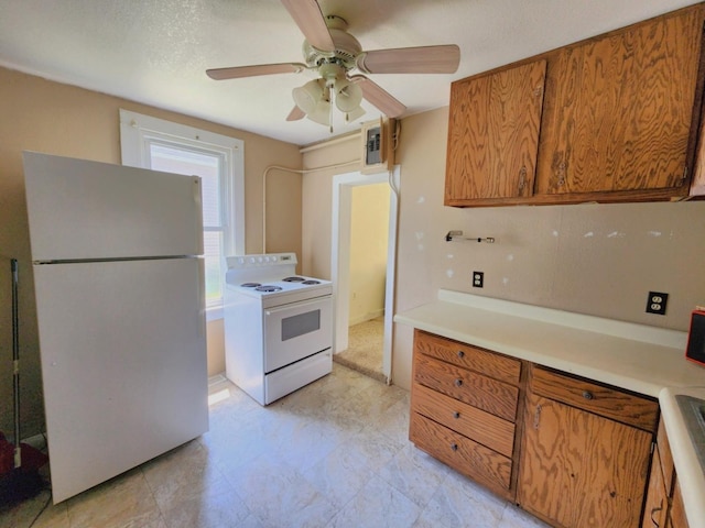 14 4th Ave SE, Dodge Center, MN 55927 - kitchen with white appliances, brown cabinetry, ceiling fan, and light countertops