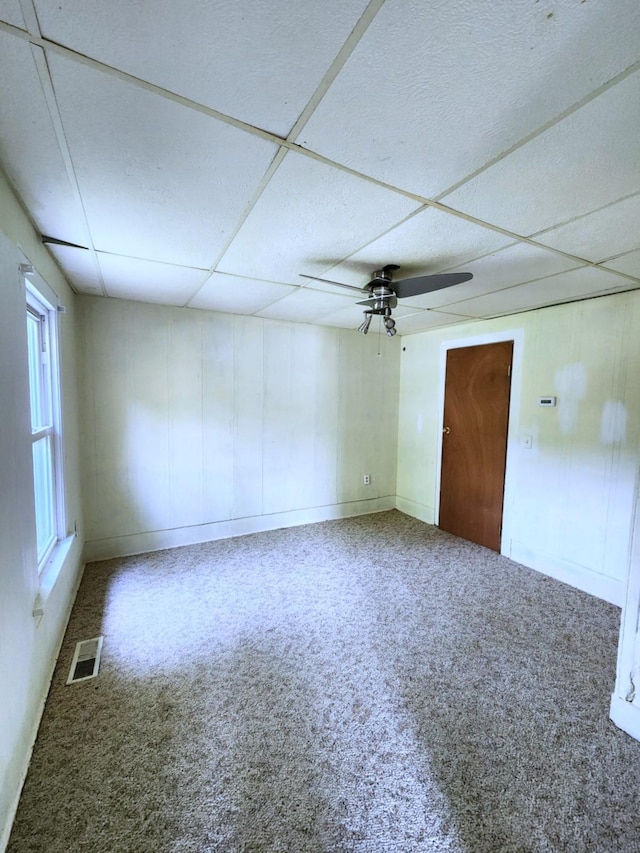 14 4th Ave SE, Dodge Center, MN 55927 - unfurnished room featuring ceiling fan, baseboards, a paneled ceiling, and carpet floors
