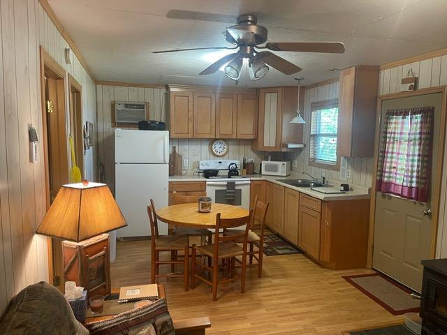 4716 Big Rice Lake Rd NE, Thunder Lake Twp, MN 56672 - kitchen with white appliances, a ceiling fan, light countertops, a sink, and light wood-style floors