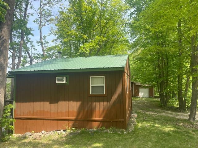 4716 Big Rice Lake Rd NE, Thunder Lake Twp, MN 56672 - view of home's exterior featuring an outdoor structure and metal roof