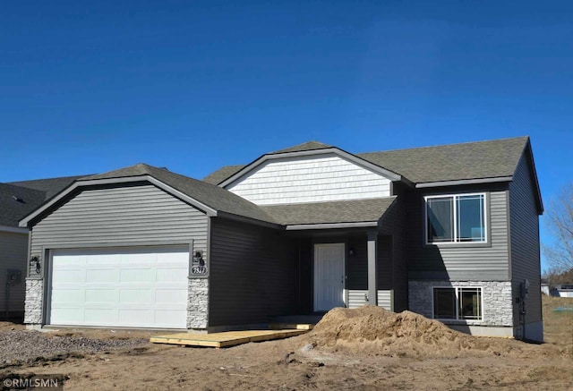 7471 147th Ln NW, Ramsey, MN 55303 - view of front of house with an attached garage, a shingled roof, and stone siding